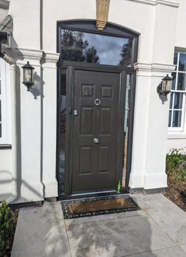 An extremely prominent Onyx Black Colonial Rockdoor, with Coastal ring knocker and Coastal finger pulls, fitted in Hatfield